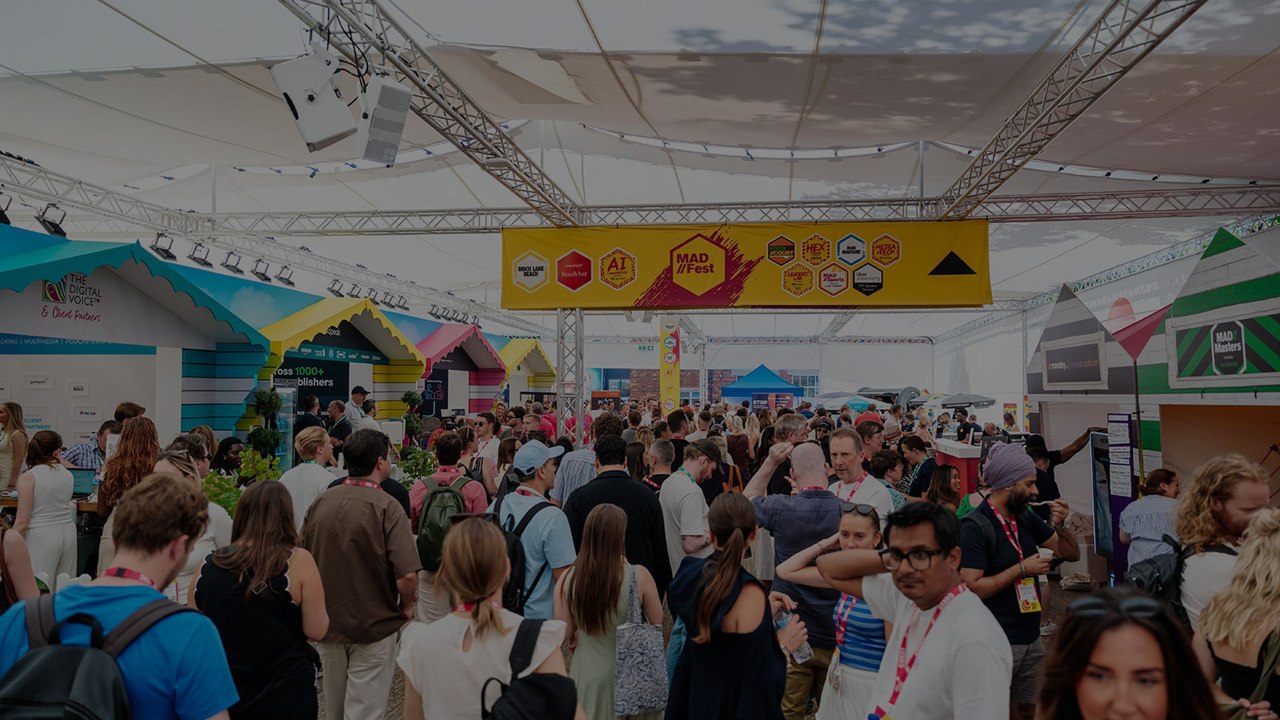 Attendees gathering in a busy MAD//Fest event space.